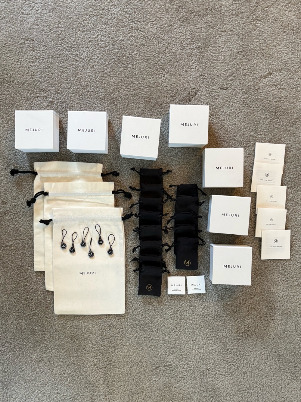 Set of Mejuri boxes and pouches